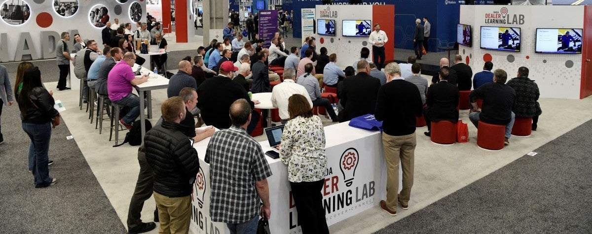 Dealer Learning Lab booth with overhead banner