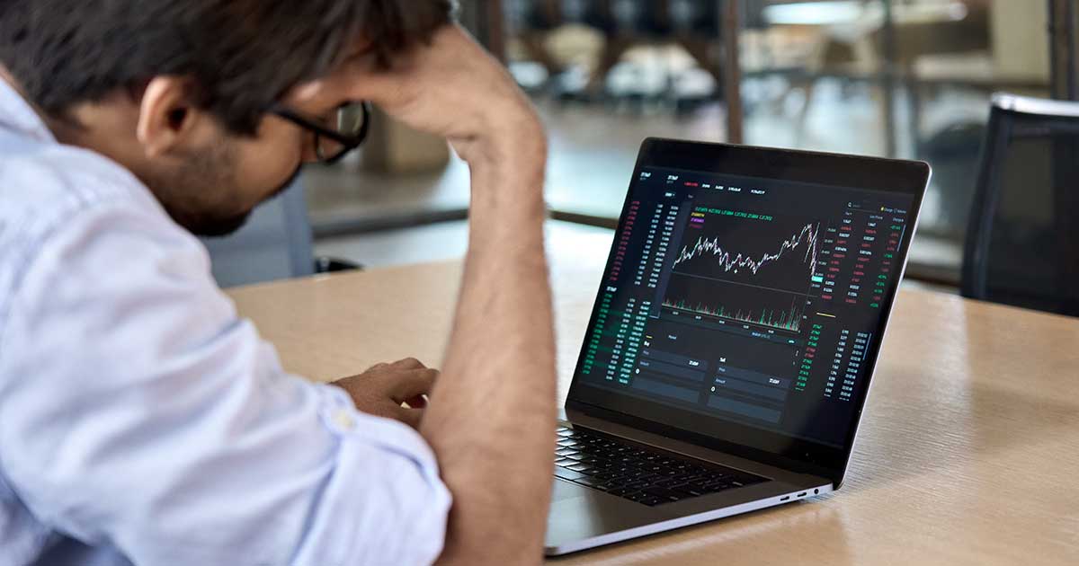 Depressed Man Looking At Data Graphic On Laptop Computer Recession depressed-man-looking-at-data-graphic-on-laptop-computer-recession