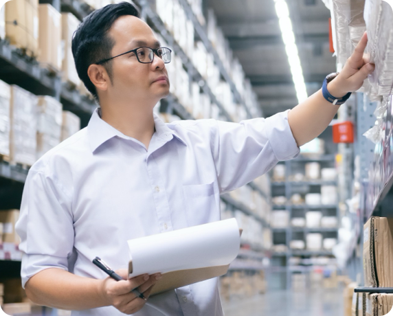 Auto parts factory manager looking at inventory.