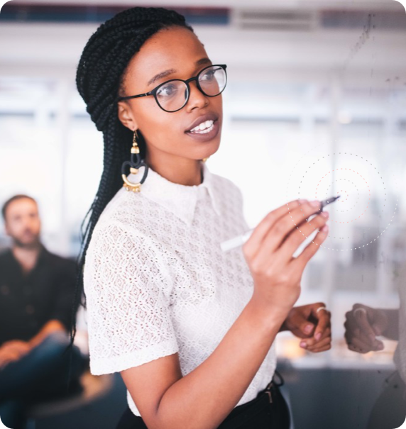 Businesswoman writing on white board in a meeting